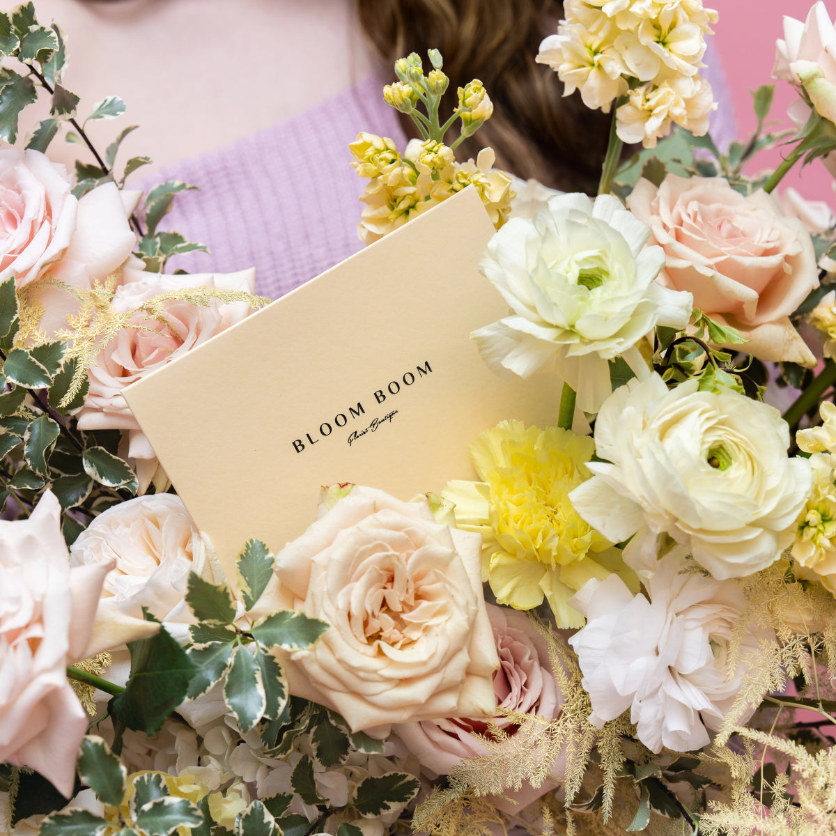 Bloom Boom luxury flower arrangement with blush roses, white ranunculus, and yellow flowers in pastel bouquet