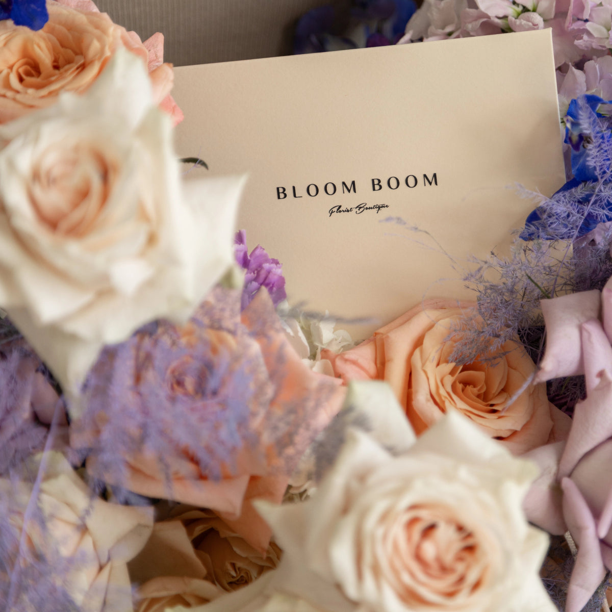 Bloom Boom flower bouquet with peach roses, purple hydrangea, and lavender blooms in elegant arrangement