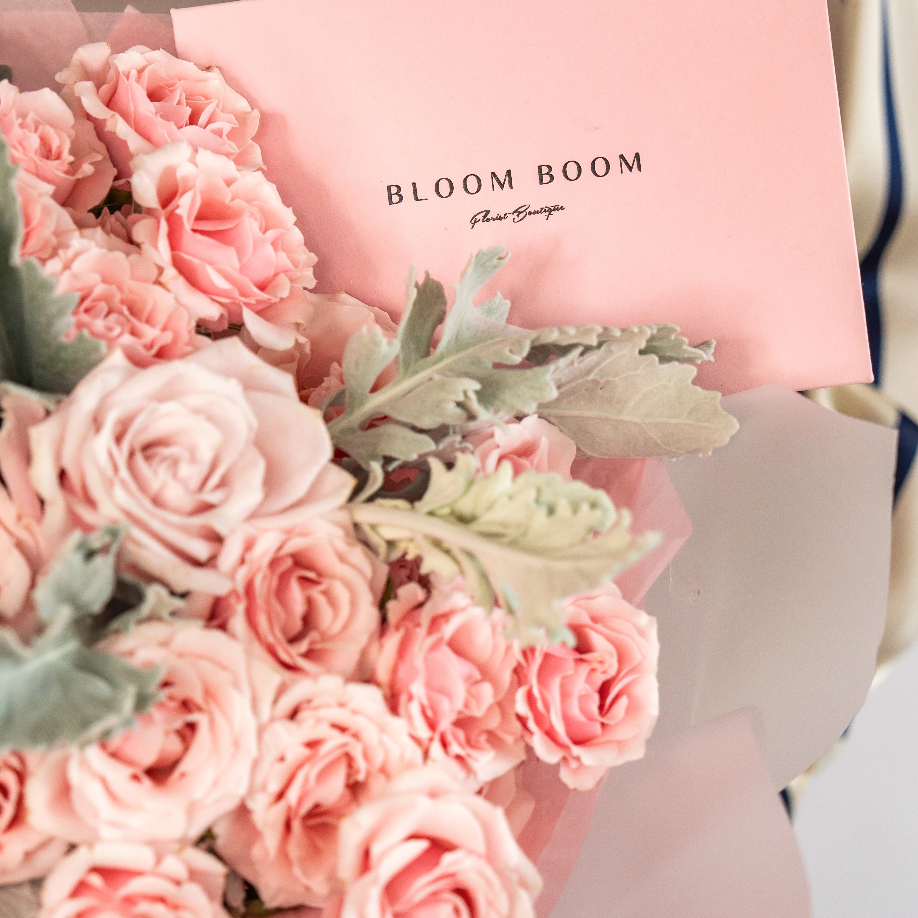 Pink rose bouquet with Bloom Boom Flower Boutique branded gift bag and white ribbon for flower delivery