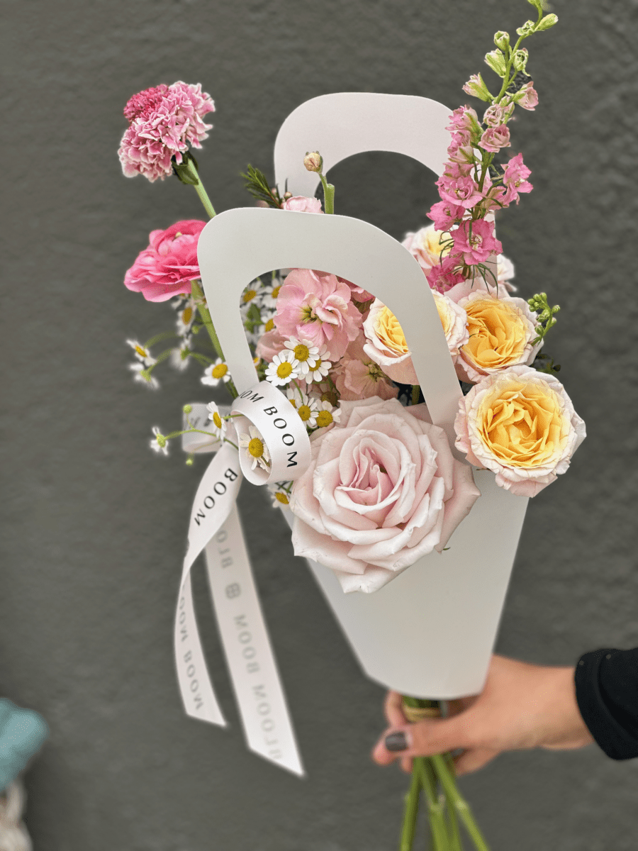 The Grand Jeté — 7-stem premier bouquet of peach garden roses, pink delphinium, carnations and chamomile in a white handle tote, by Bloom Boom for Tutu School