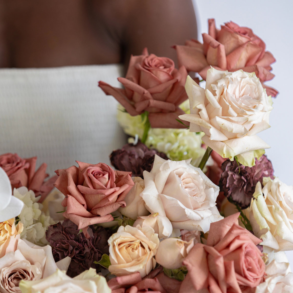 Mixed rose bouquet in cafe latte tones with blush pink, cream, burgundy and white roses plus hydrangea blooms