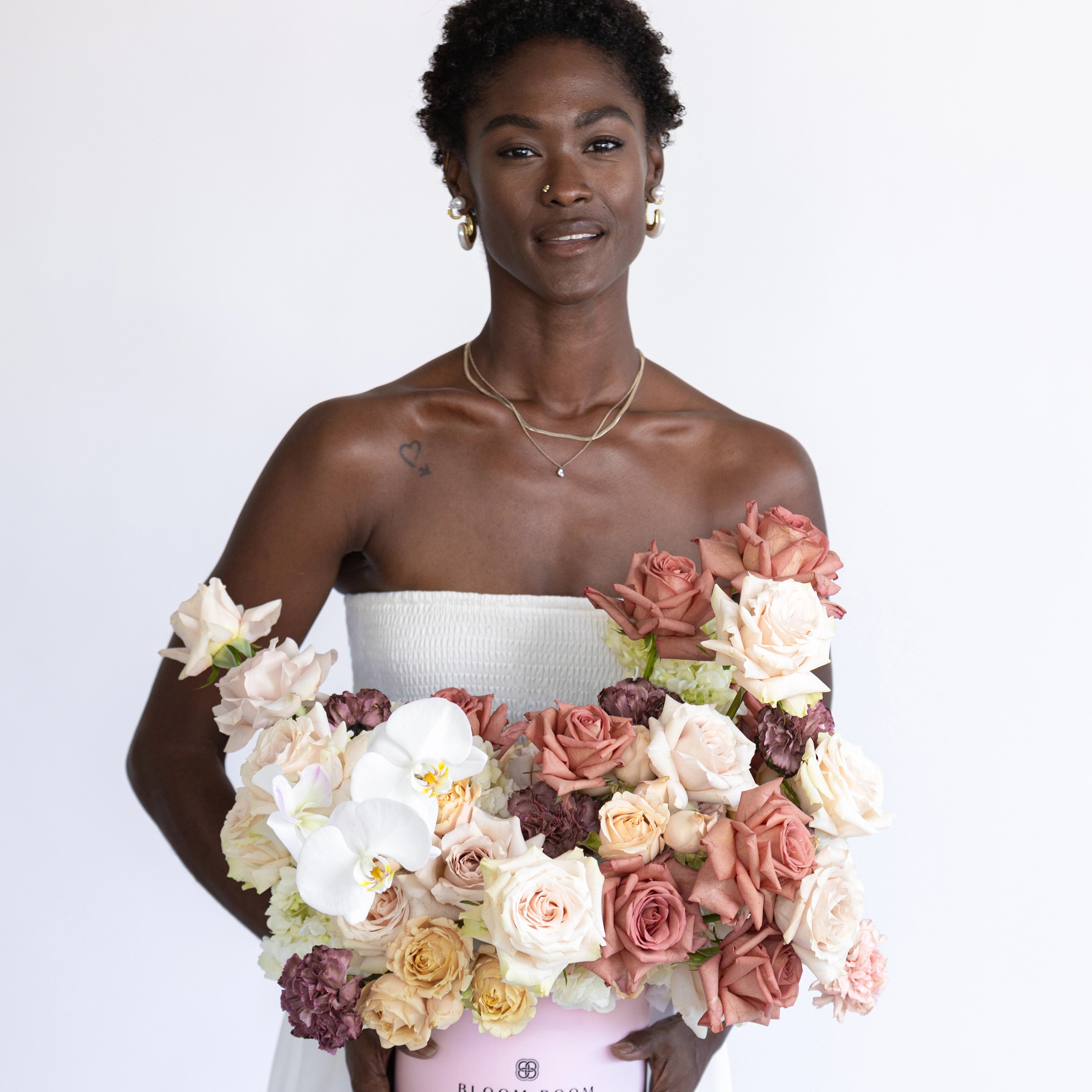 Luxury wedding bouquet with coral roses, cream roses, white orchids and burgundy flowers for Los Angeles bride