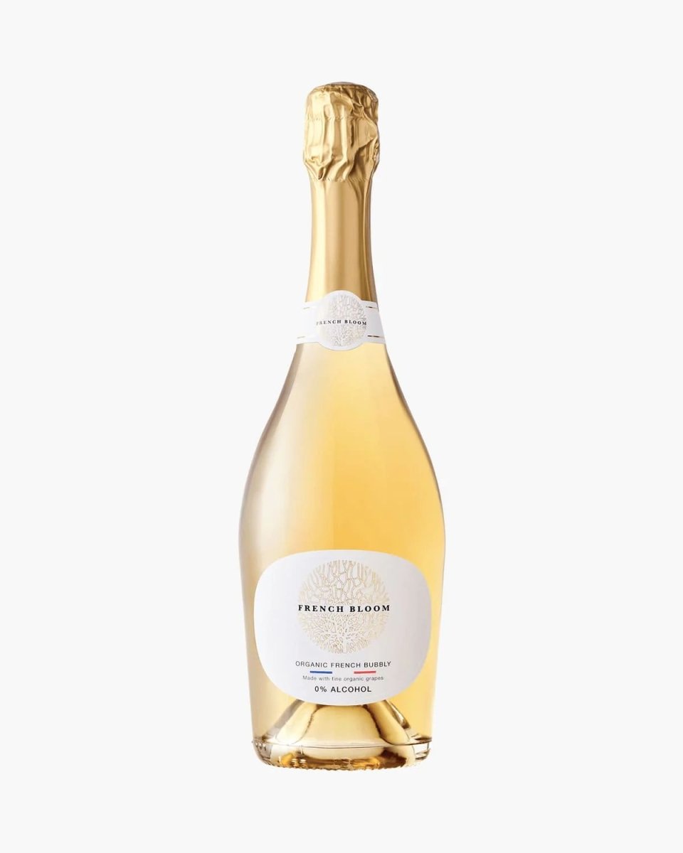 French Bloom organic sparkling wine bottle with gold foil top, white label, and pale golden liquid, 0% alcohol