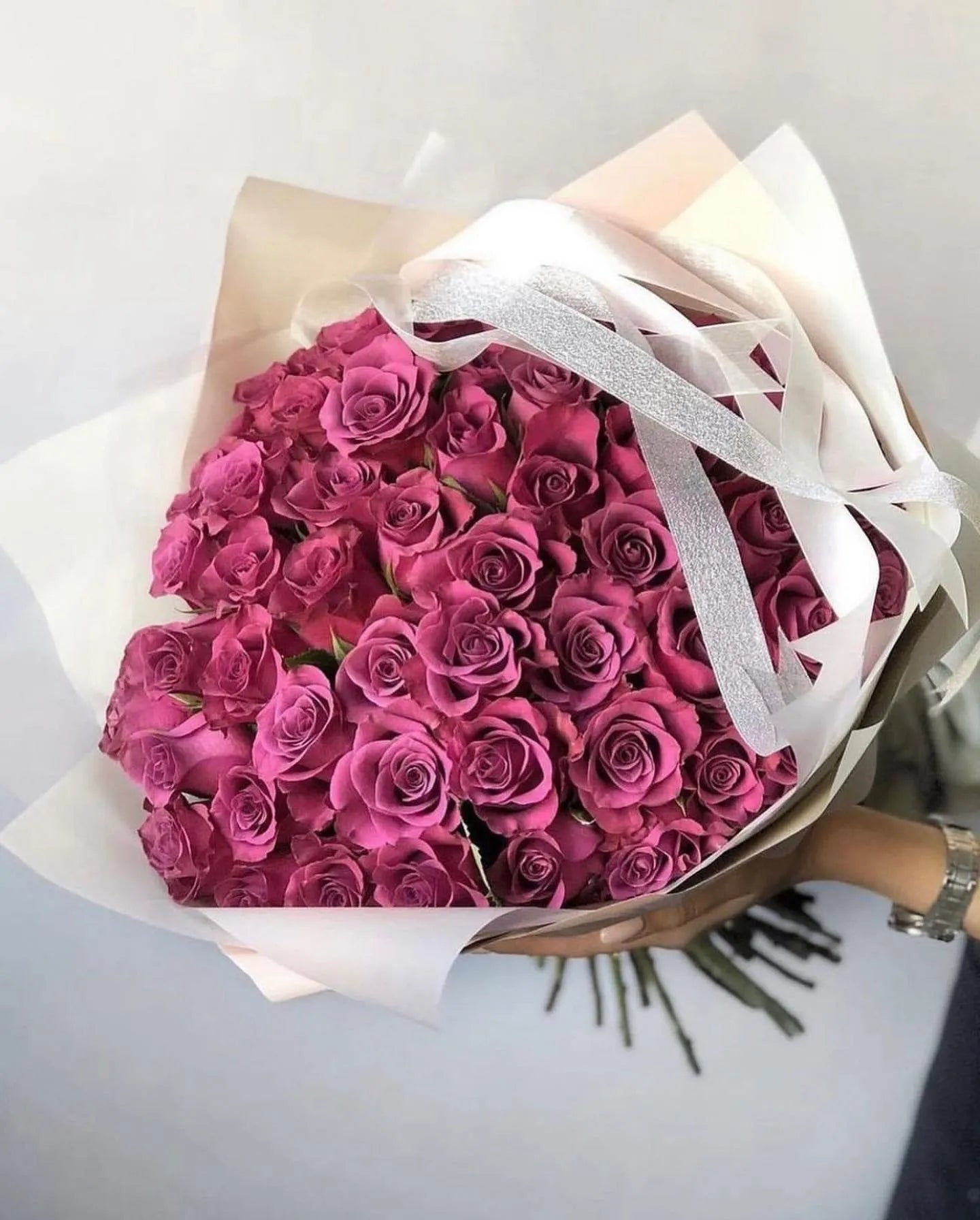 Hot pink rose bouquet wrapped in cream paper with white satin ribbon bow - premium flower delivery Los Angeles