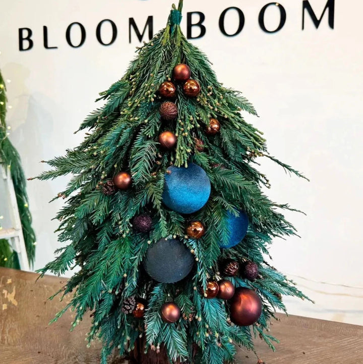 Modern blue and brown Christmas tree with twinkling lights, perfect for festive home decor. Los Angeles ☎ +1(424) 421-0224 @Bloom Boom