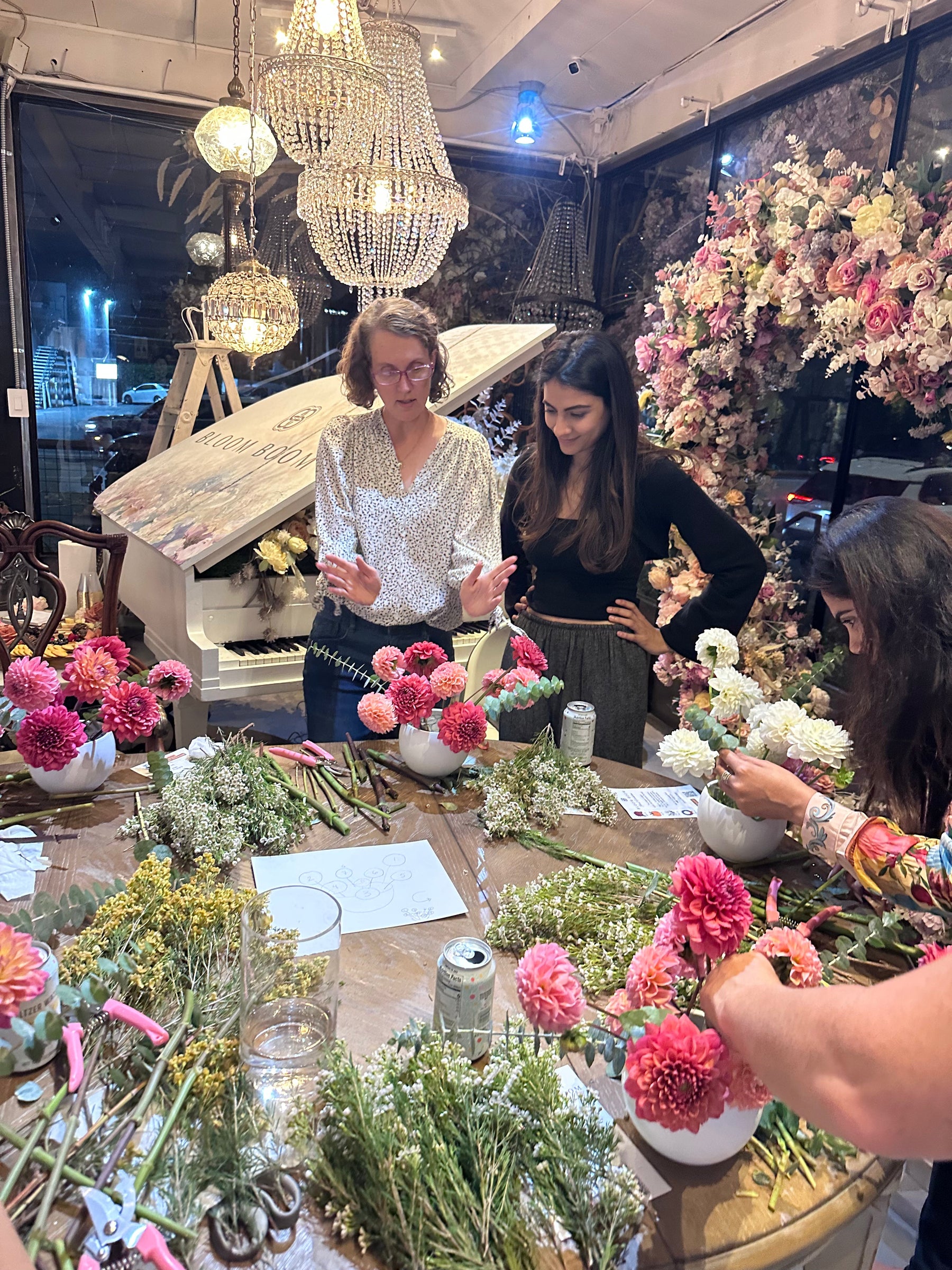 Guest arranging seasonal flowers during a Bloom Boom workshop
