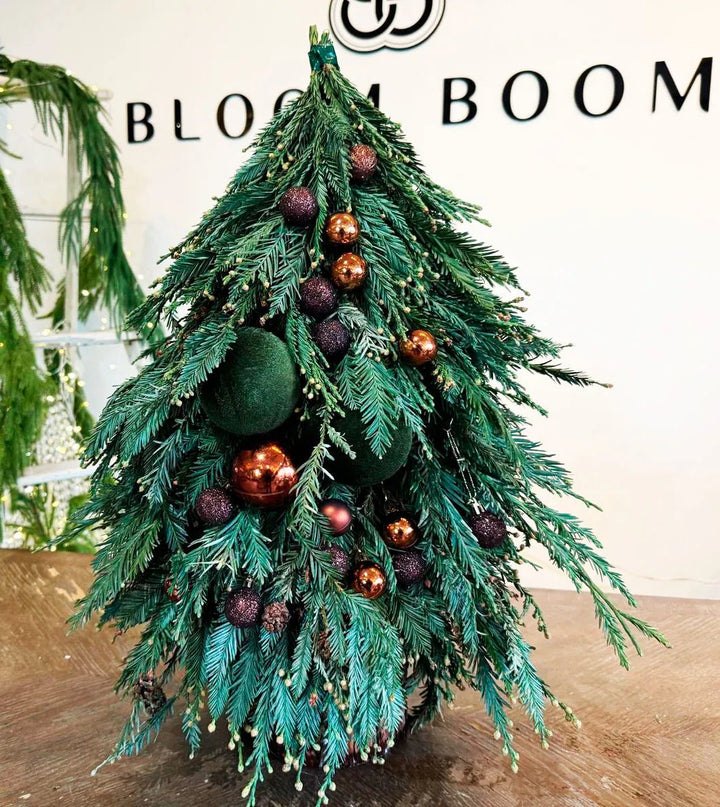 Close-up of a blue and brown Christmas tree showcasing handcrafted ornaments and cozy textures. Los Angeles ☎ +1(424) 421-0223 @Bloom Boom