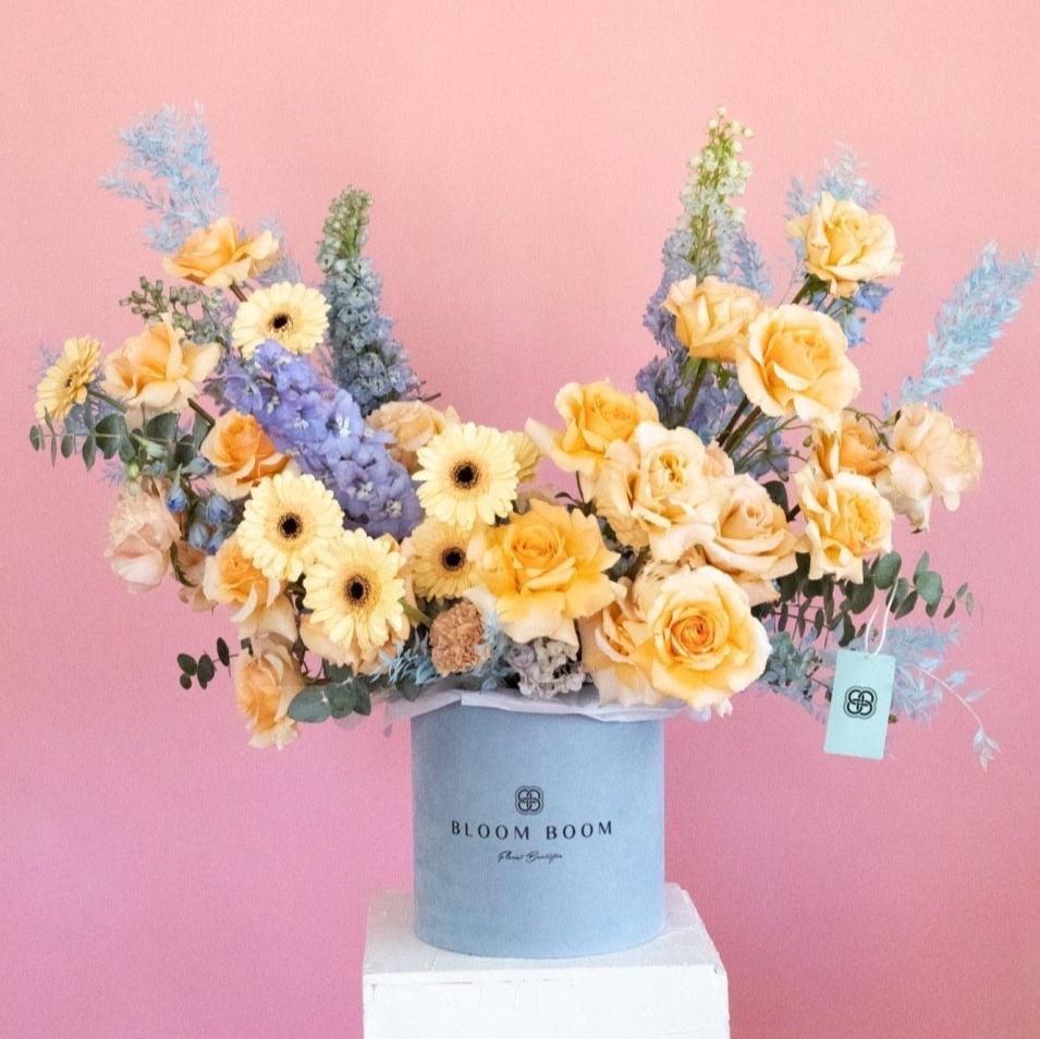 Azure Dream luxury flower box with peach roses, yellow gerberas and blue delphinium in powder blue hat box
