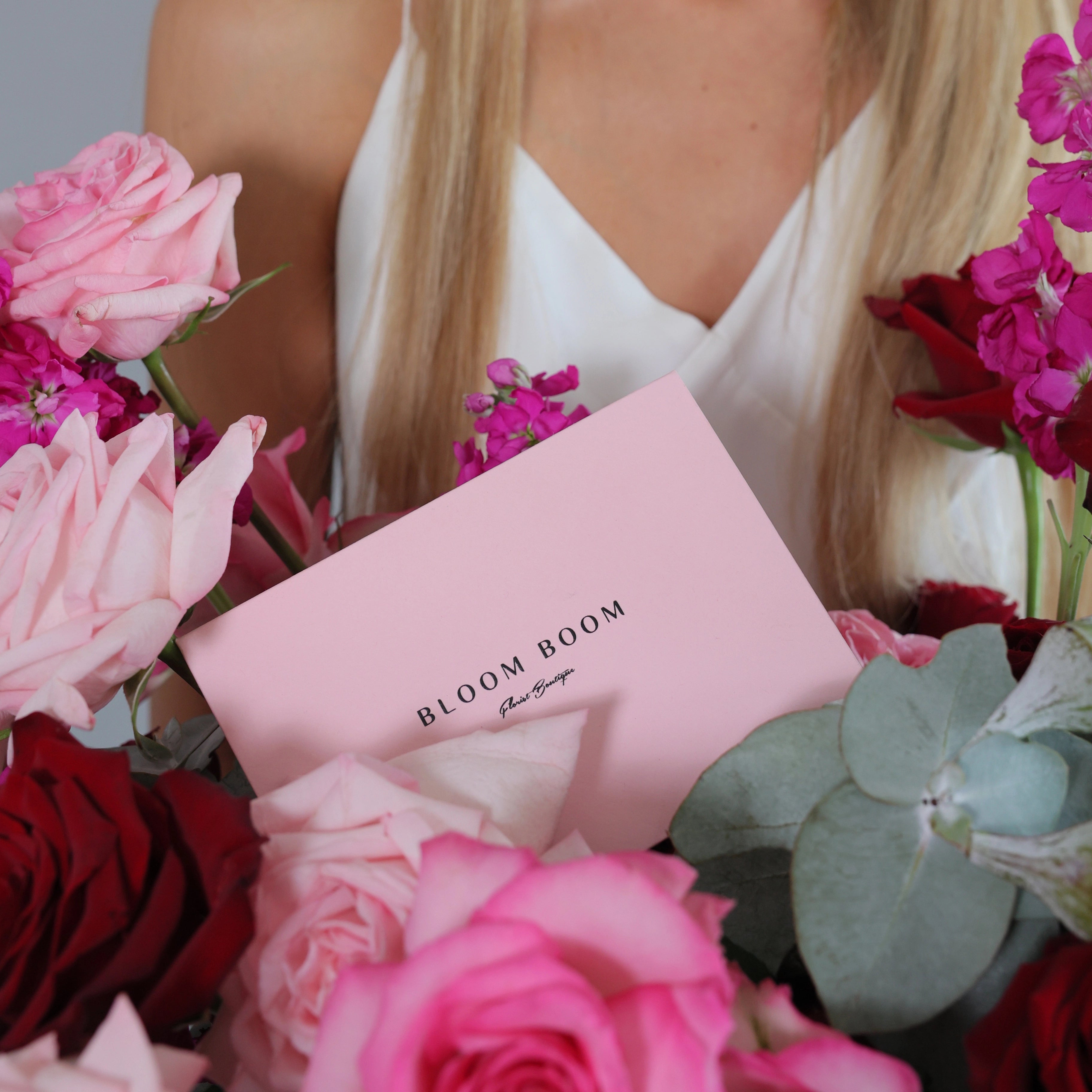 Bloom Boom pink gift card with mixed rose bouquet featuring pink roses, burgundy roses, and eucalyptus