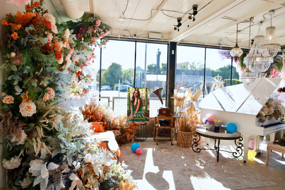 The Bloom Boom event space styled for the Guru Beauty Awards with a full floral wall, white piano and pastel balloons
