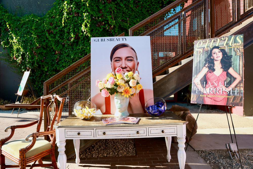 Guru Beauty Awards signage and floral arrangement staged on the outdoor patio stairs