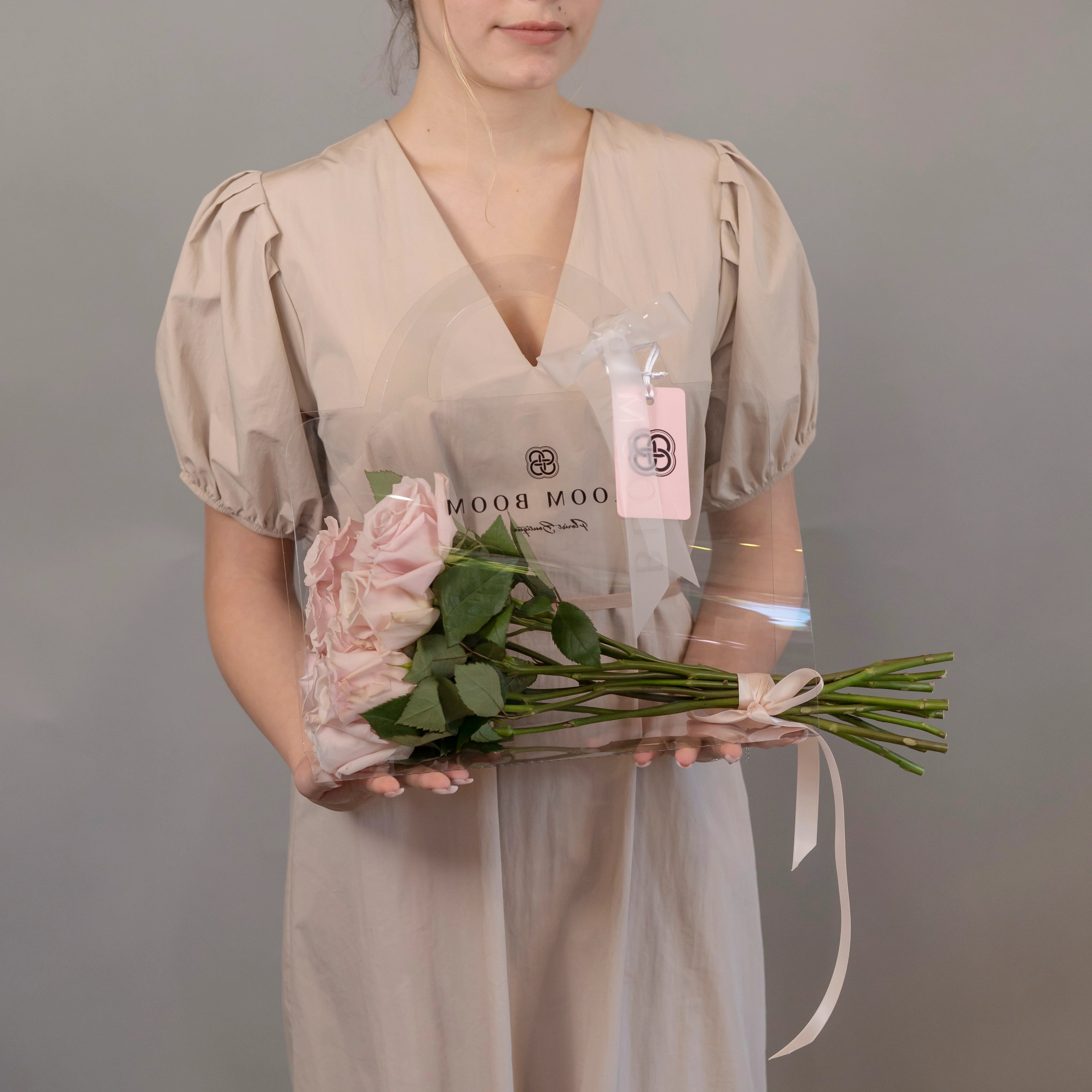 Pink rose bouquet in clear Bloom Boom gift box with branded tag, perfect for flower delivery in Los Angeles