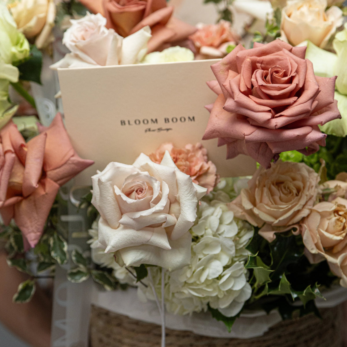 Bloom Room luxury flower arrangement with dusty rose, cream and white roses, white hydrangeas in elegant display
