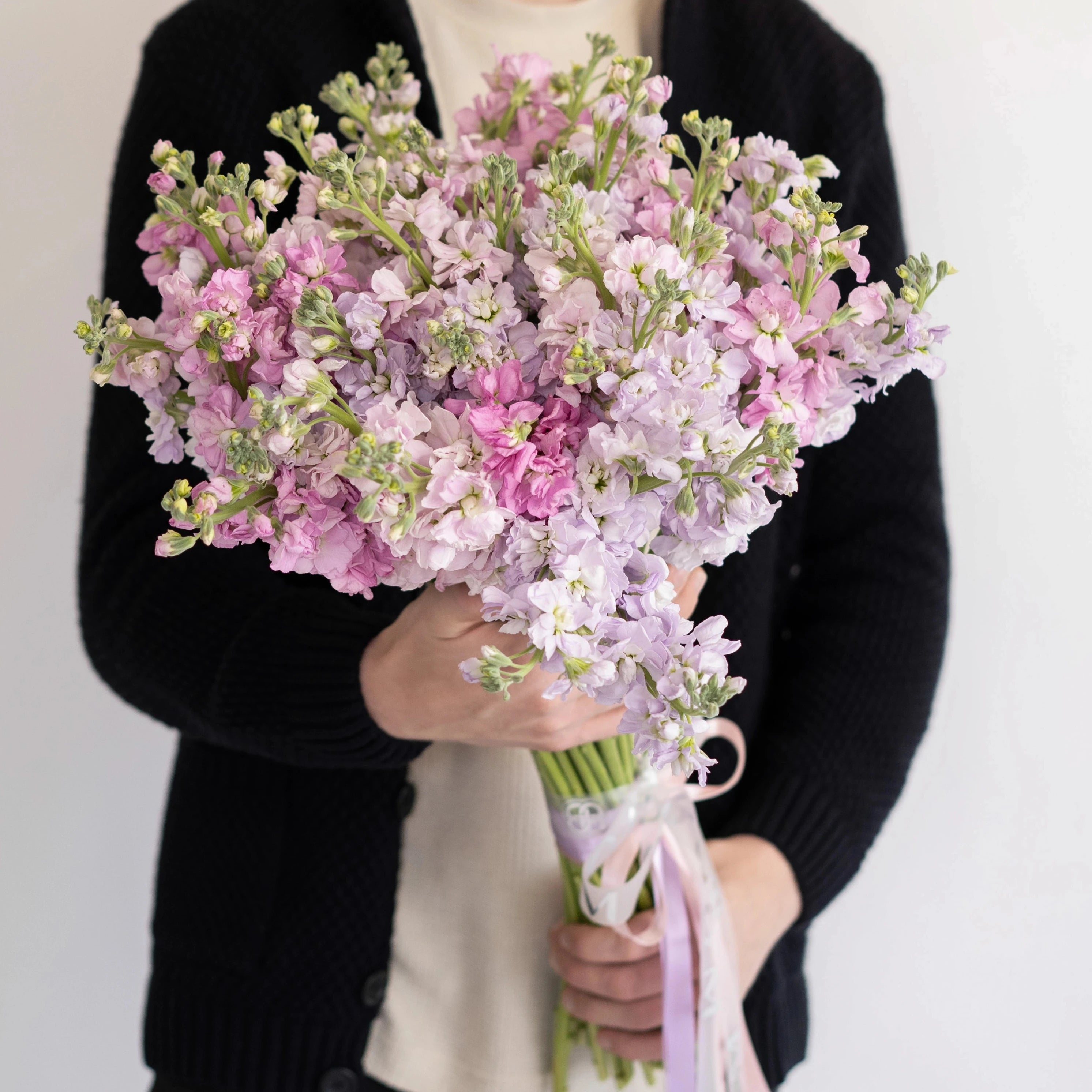 Pink and lavender stock flower bouquet with light pink ribbon perfect for weddings and special occasions