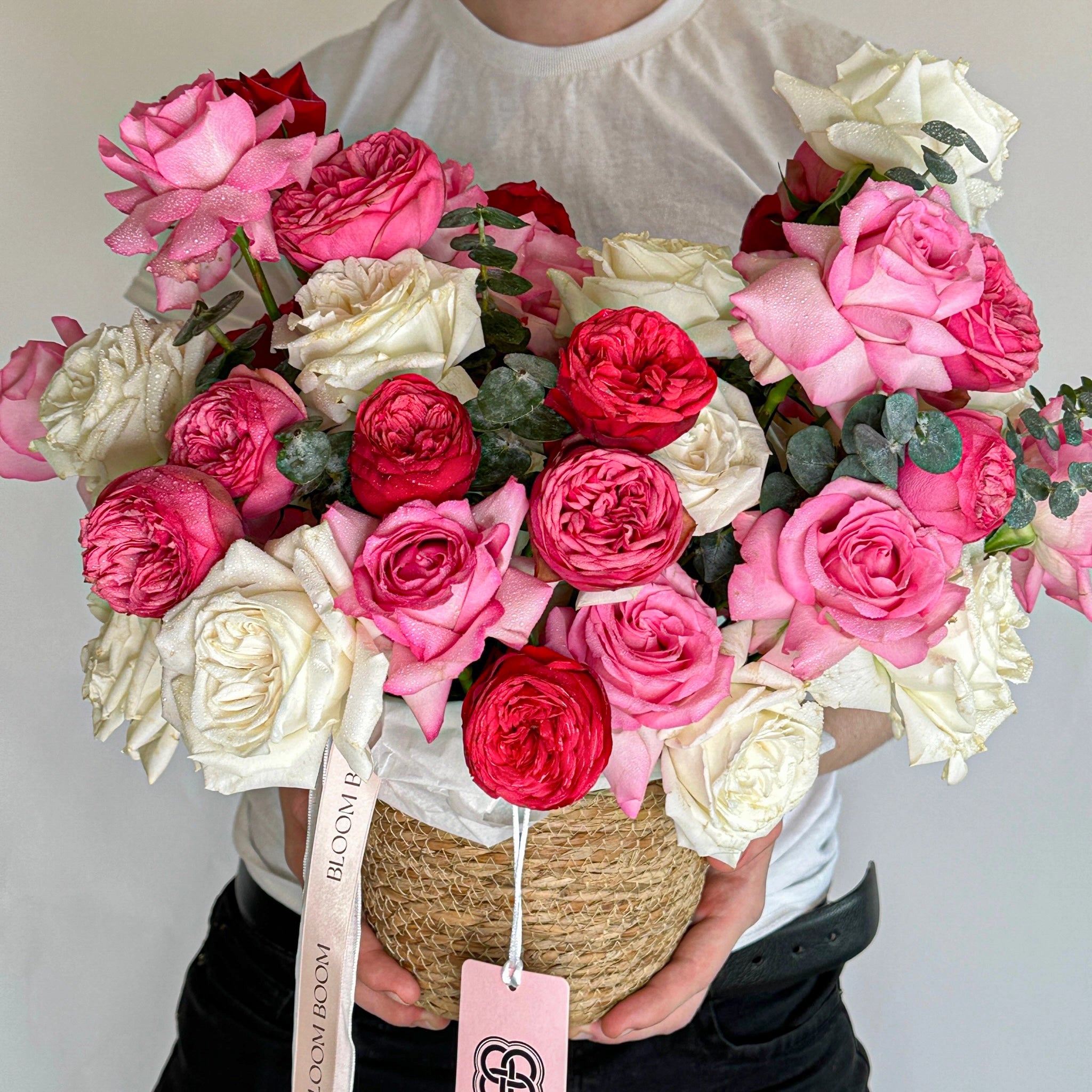Mixed rose basket arrangement with pink, red, white roses and ranunculus in woven basket - Los Angeles flower delivery