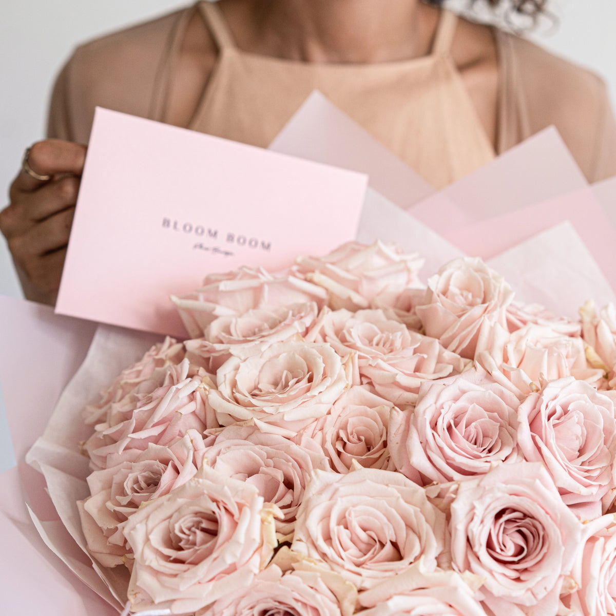 Elegant pink rose bouquet with 25 Sweet Escimo roses in white wrapping paper with Bloom Room card