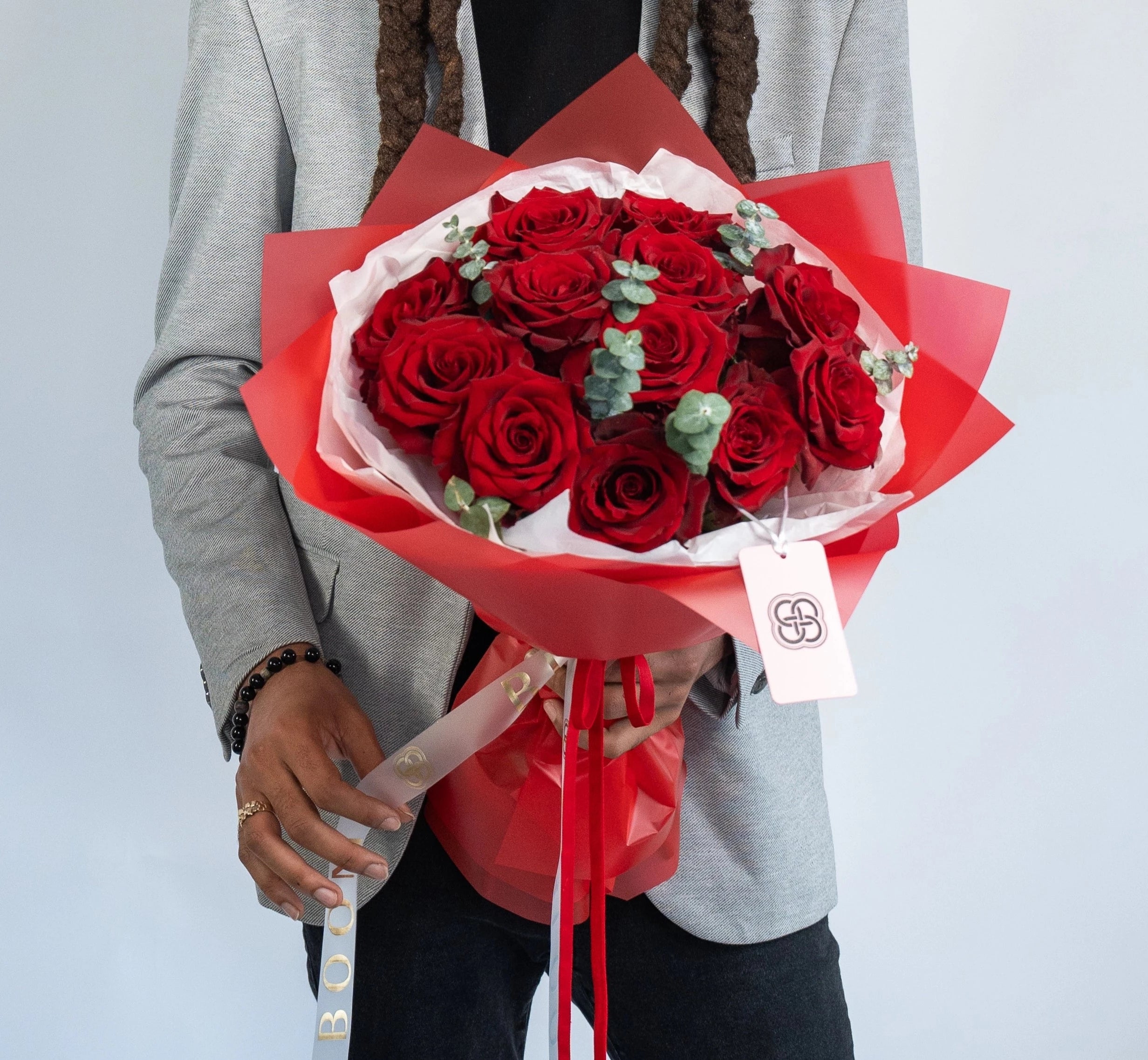 Elegant red rose bouquet with eucalyptus wrapped in red paper - perfect romantic gift delivery Los Angeles