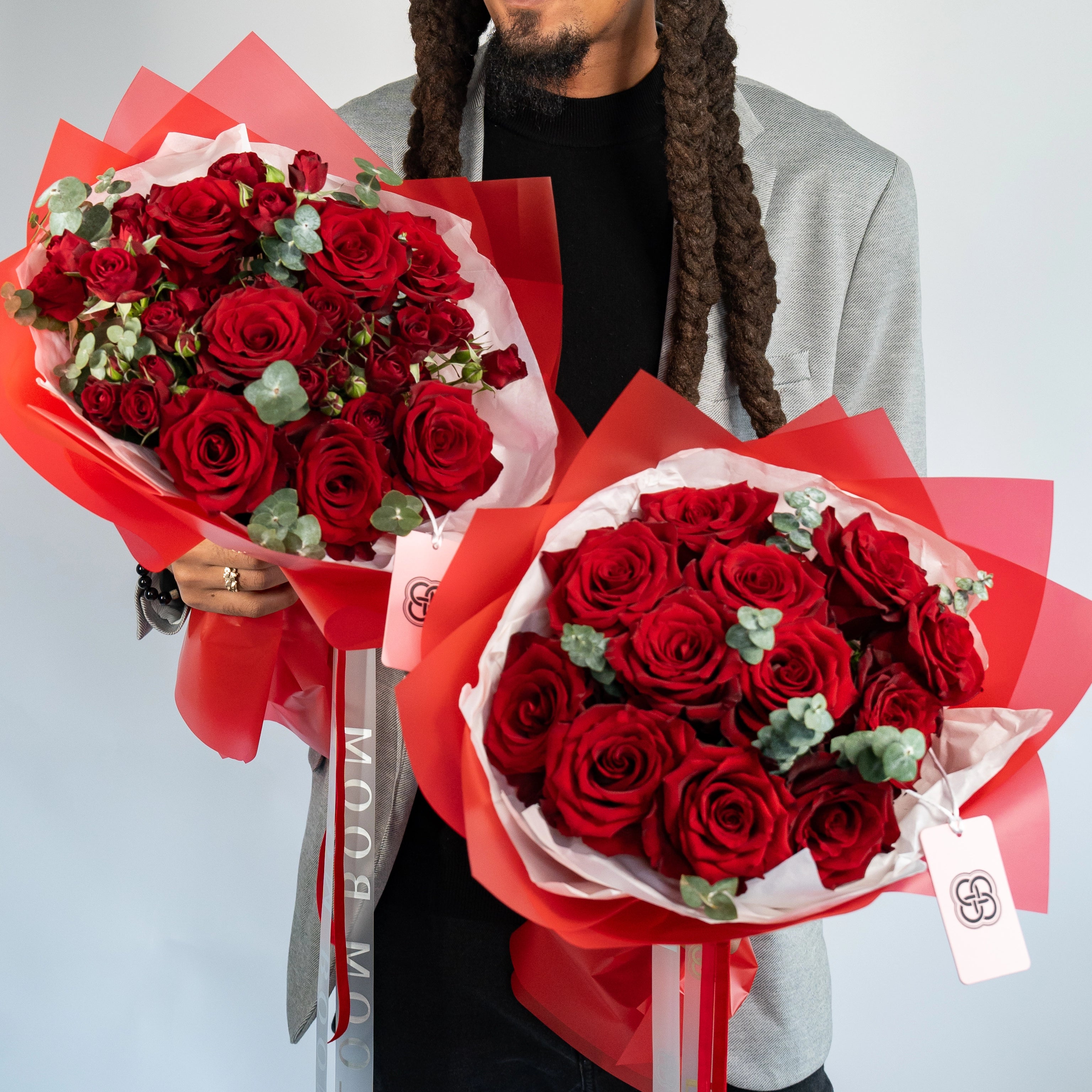 Two red rose bouquets with eucalyptus in red pink wrapping, perfect Valentine's Day gift set from Bloom Boom