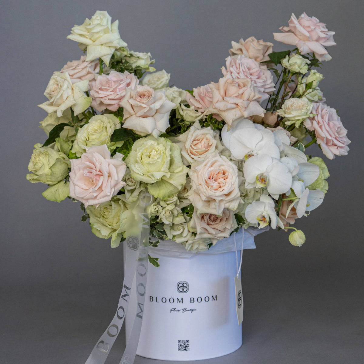 White luxury flower box with pale pink roses, green hydrangeas, white orchids and cream roses arranged elegantly